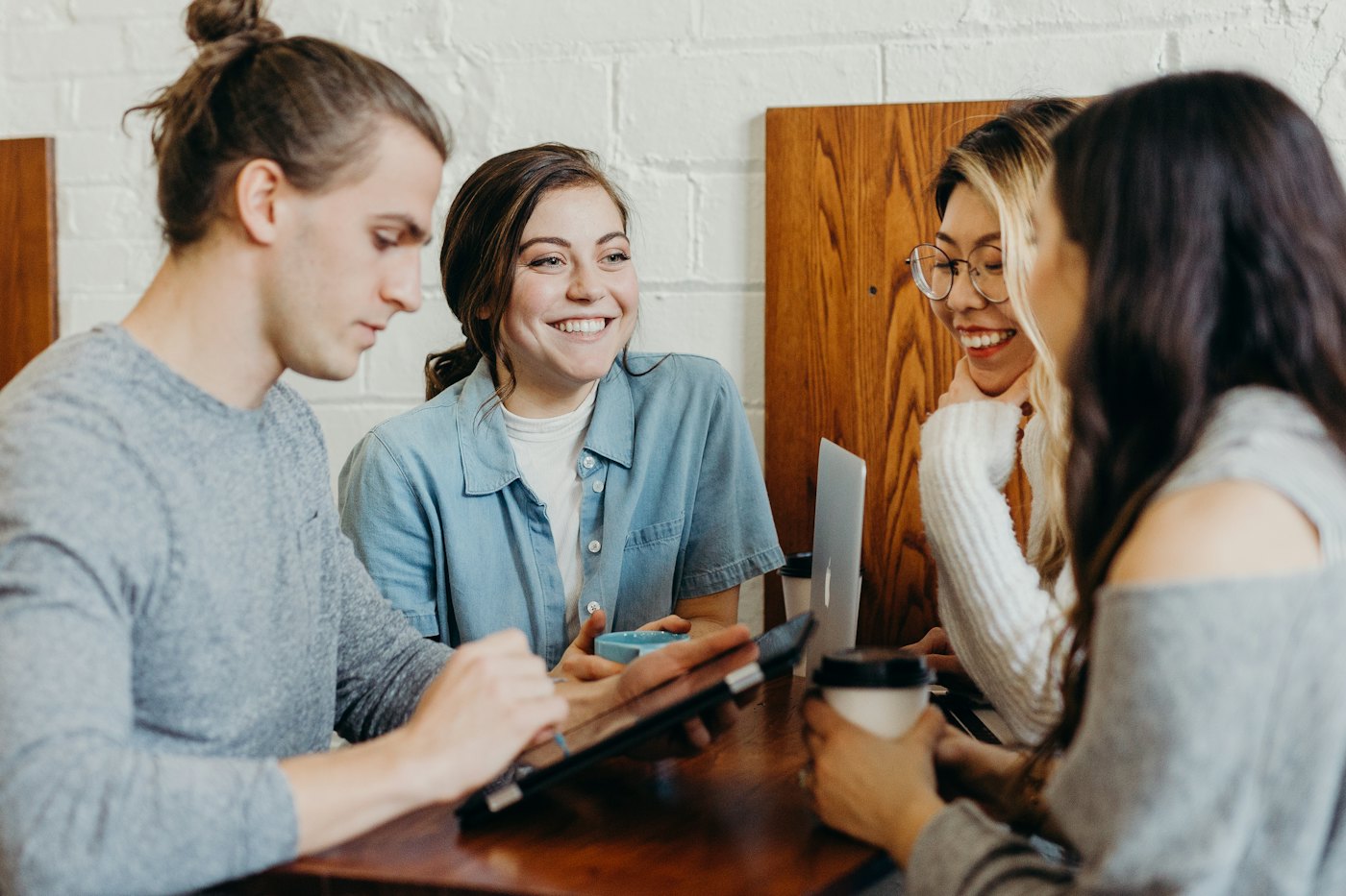 Friends laughing in a café from the café sample